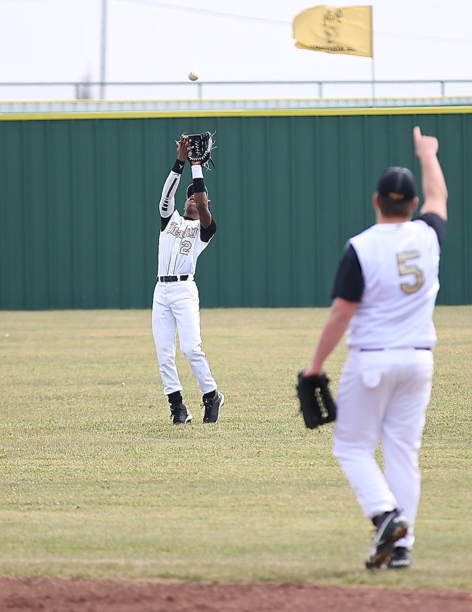 Image: Senior second-baseman Zain Byers(5) spots the ball for senior center fielder Eric Carson(2) who makes the catch.