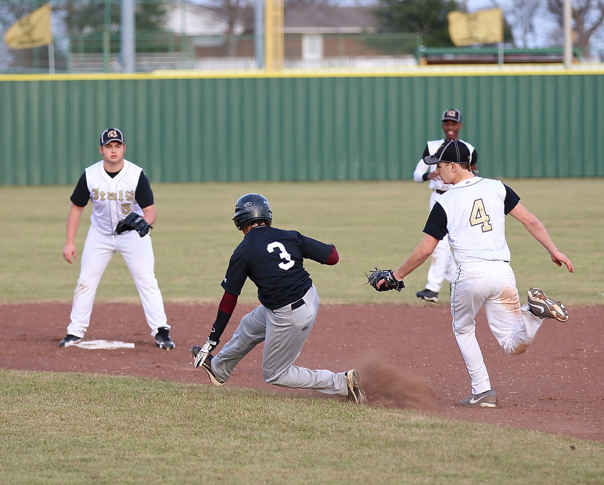 Image: Ryan Connor chases down a Faith Family runner between first and second-base.