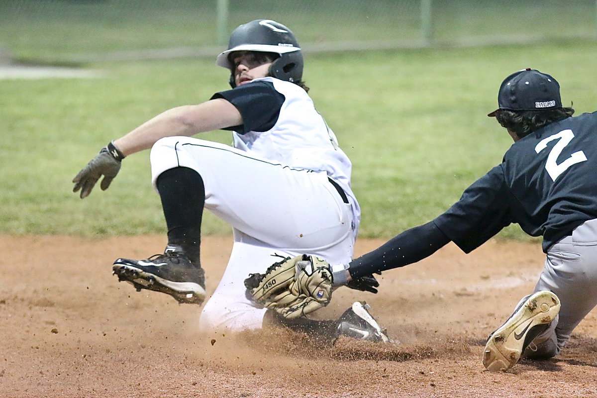 Image: Gladiator Kyle Fortenberry(14) slides safely across home plate.