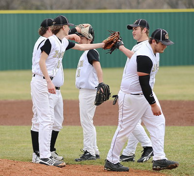 Image: The infield wishes pitcher Ty Windham(12) good luck during Italy’s game against Roosevelt.