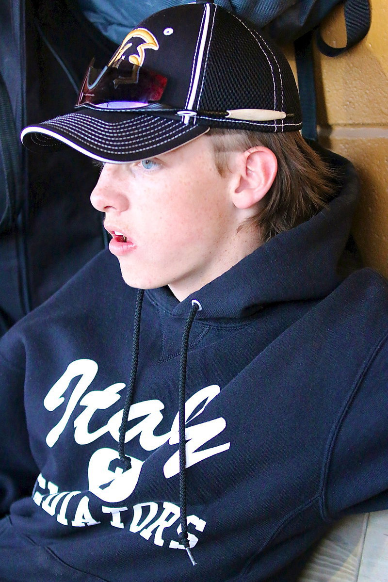 Image: Ty Windham(12) relaxes inside the dugout.