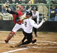 Image: Madison Washington(2) slides into home as teammate Jaclynn Lewis(15) yells for her to slide.