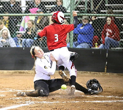 Image: Madison Washington(2) slips across home plate while trying to tag out a Maypearl runner stealing home.