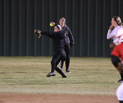 Image: Lady Gladiator Cassidy Childers fields a ball hit into the outfield with Kelsey Nelson and Hannah Washington backing up the play.