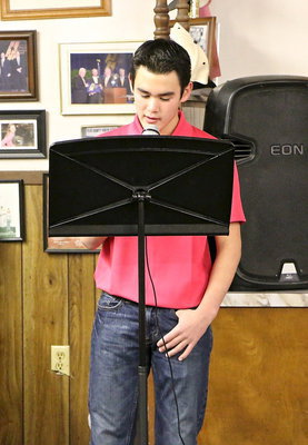 Image: Junior High Band member Kyle Tindol sings a country song for the audience.