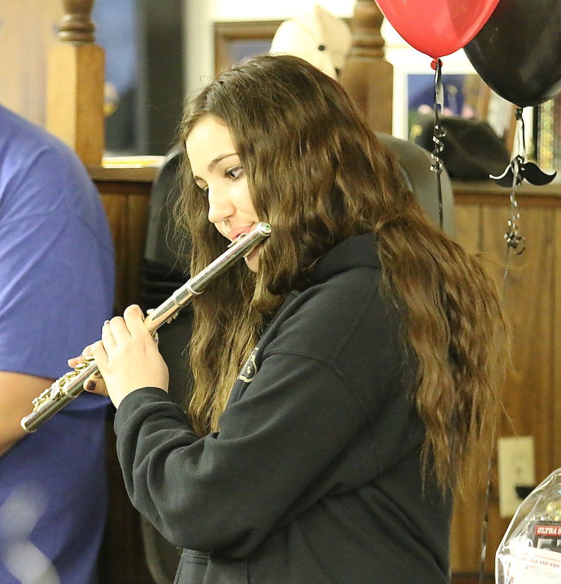 Image: Assistant drum major Alexis Sampley plays a heavenly flute for those in attendance.