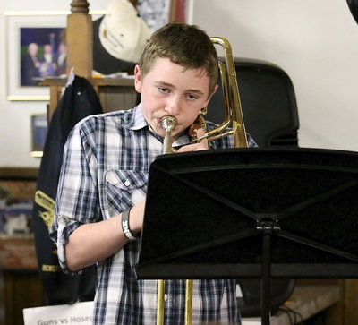 Image: Junior High Band member Hunter Morgan entertains via the trombone.