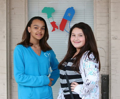 Image: Skyler Lemley and Alexya Molina pose for pic in front of the old barber shop down from the Uptown Cafe. Just taking a break from the band spaghetti dinner.