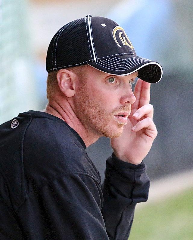 Image: Gladiator head coach Jon Cady gives a sign to his defense.