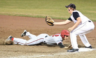 Image: Maypearl’s Brett Pickard slides back safely to first with Italy’s Bailey Walton defending. Pickard played summer league baseball with the Gladiators in the past.