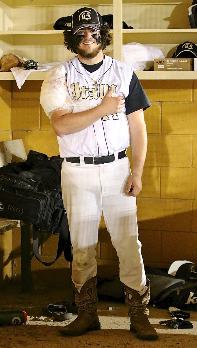 Image: Baseball in Italy, Texas: Kyle Fortenberry(14) ices the shoulder while relaxing in a pair of boots.