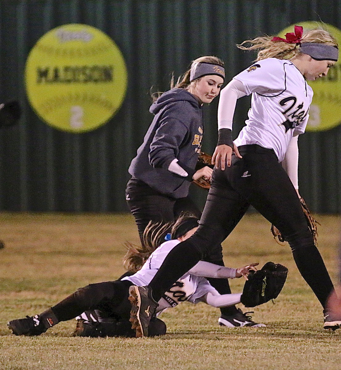 Image: Tara Wallis(5) tries to avoid colliding with teammates Kelsey Nelson(14) and Jaclynn Lewis(15) as Wallis attempts to hang on to a Panther popup.