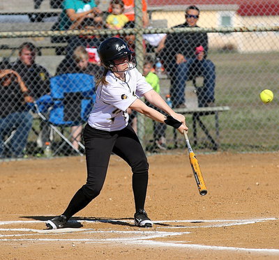 Image: Lady Gladiator Kelsey Nelson(14) makes contact and then hurries to first-base.