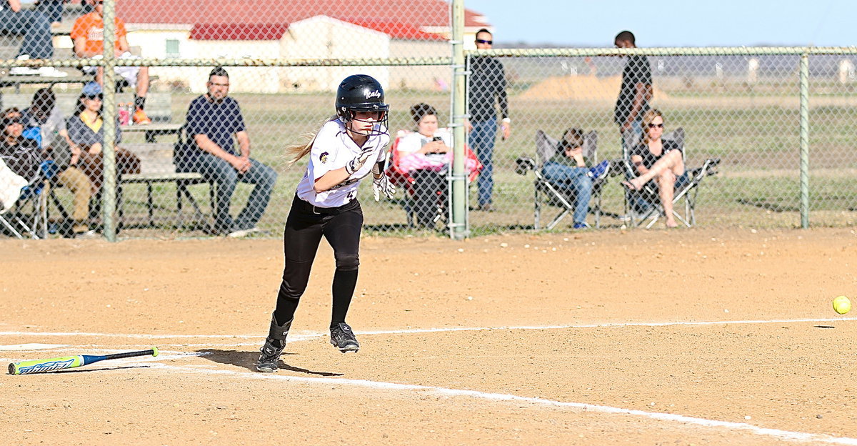 Image: Italy’s Britney Chambers(4) slaps a shot down the third-base line.