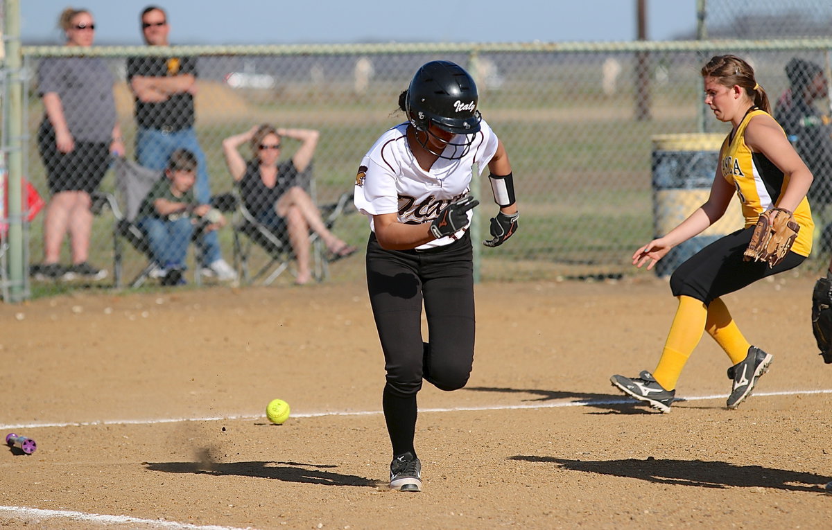 Image: April Lusk(18) bunts, runs fast and reaches first-base in time against Itasca.