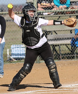 Image: Senior catcher Paige Westbrook(10) practices a throw-down to second-base.