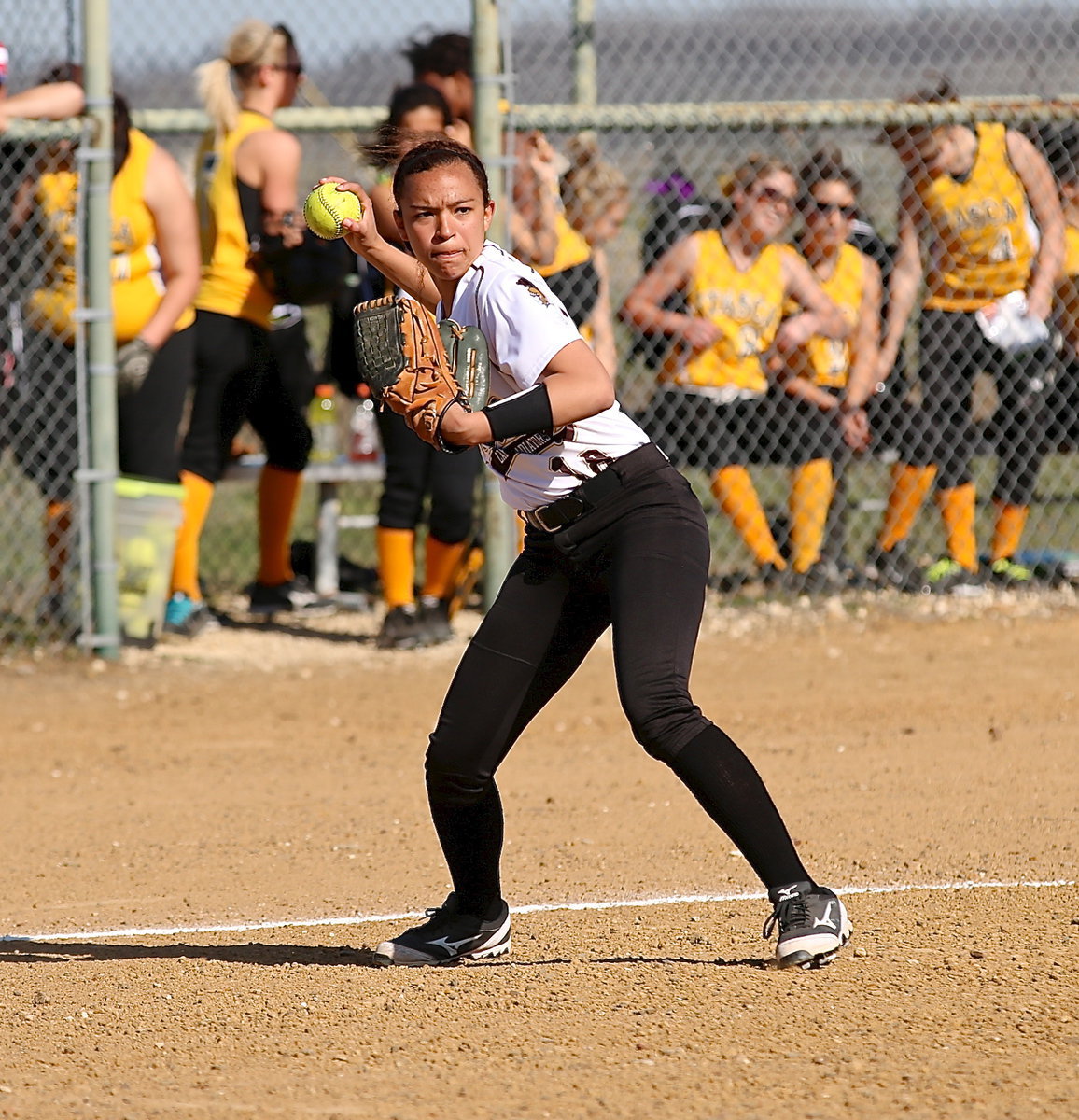 Image: Italy’s April Lusk(18) warms up at third-base.