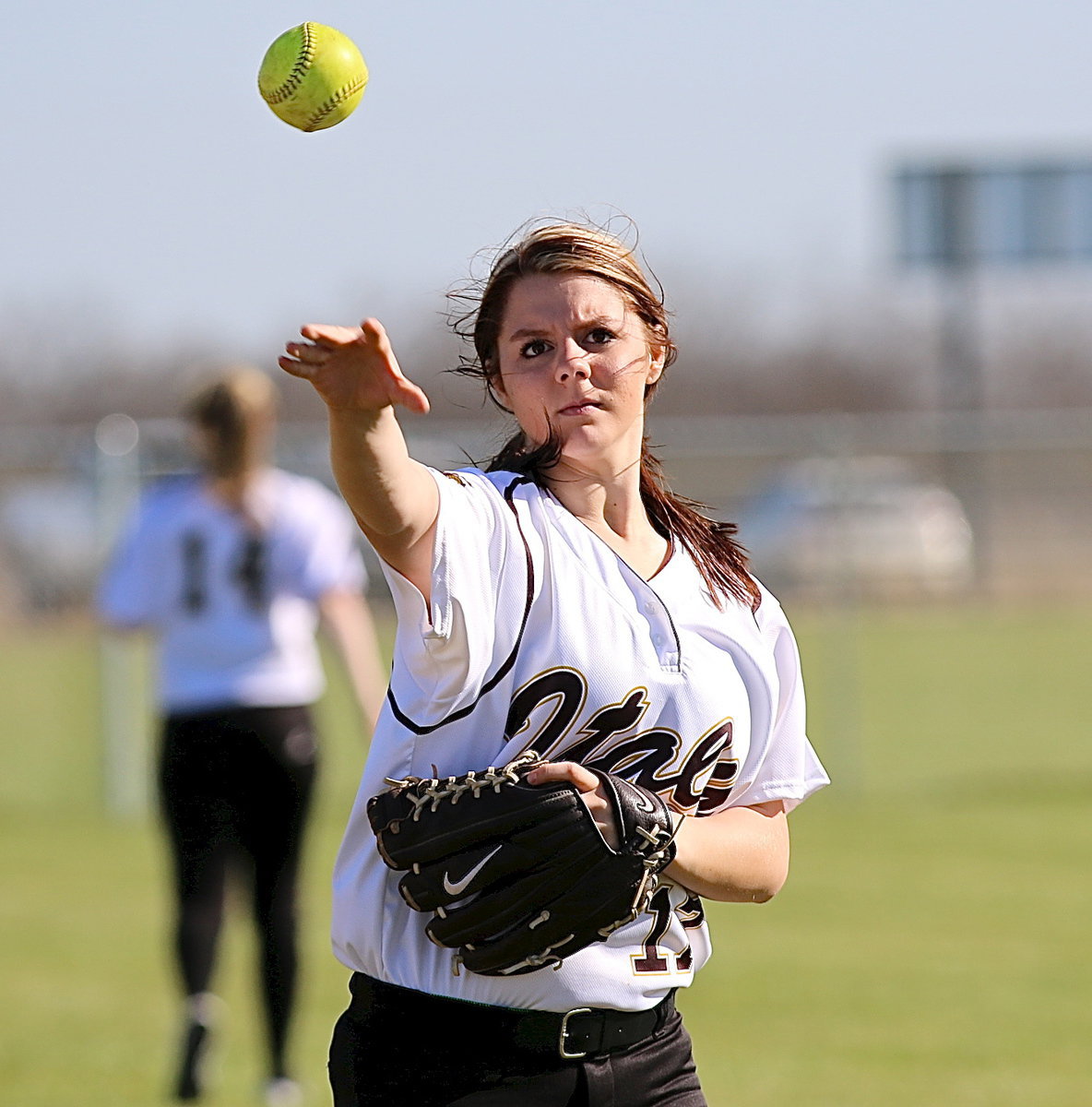 Image: Outfielder Brooke DeBorde warms up between innings.