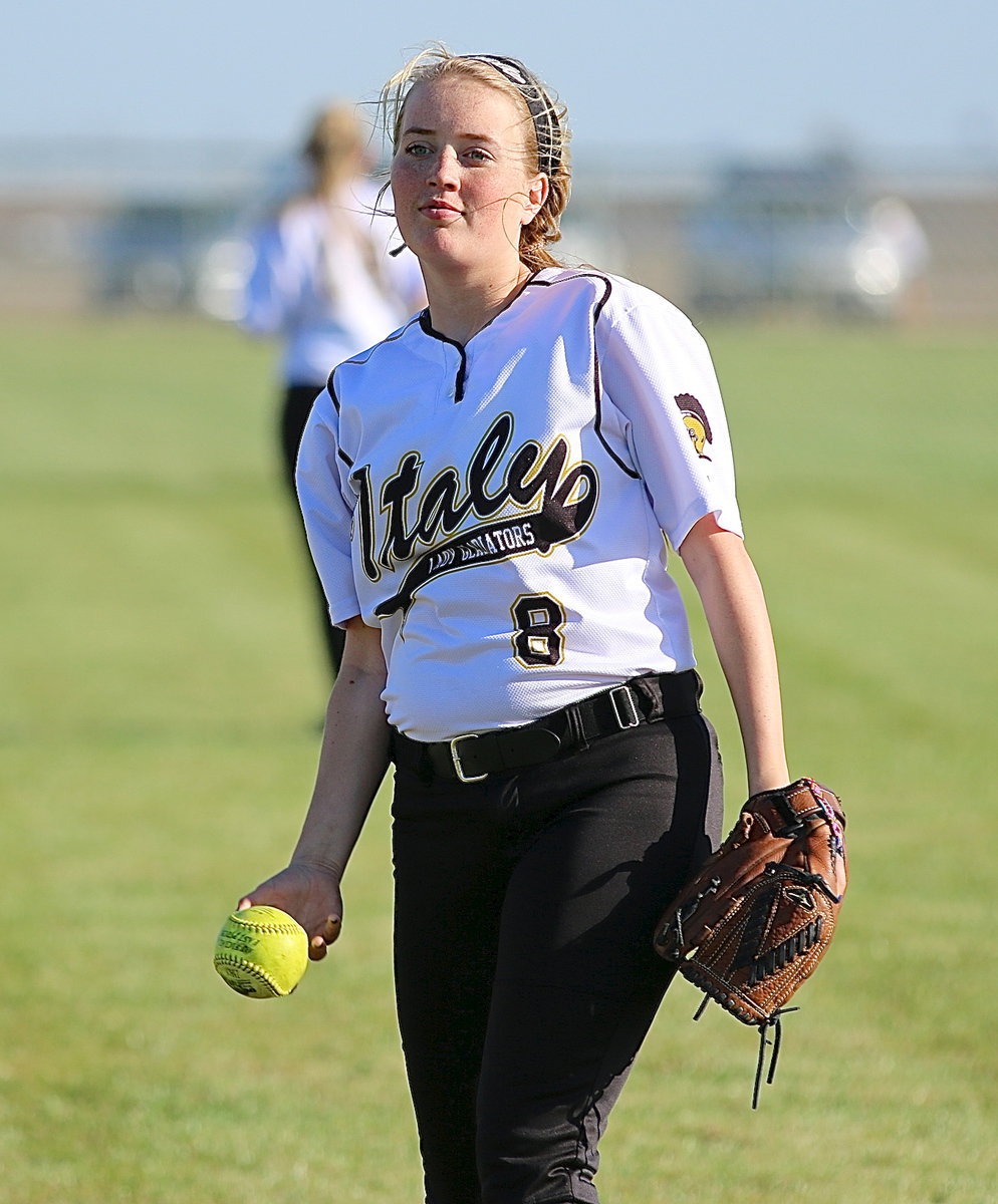 Image: Hannah Washington(8) warms up with the outfielders.