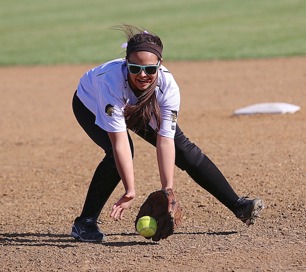 Image: Ashlyn jacinto(6) covers a grounder during warmups.