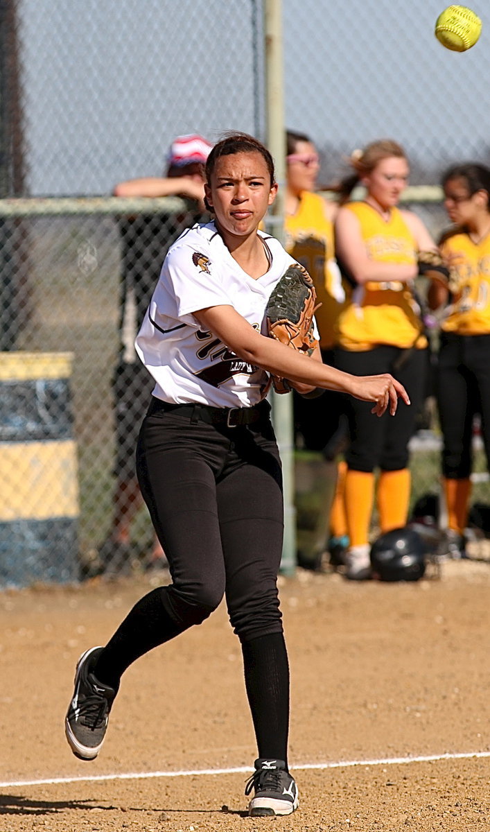 Image: April Lusk(18) has an arm as as she warms up at third-base.