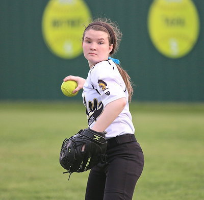 Image: Right fielder Tara Wallis(5) warms up before the start of the game.