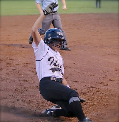 Image: April Lusk(18) successfully reaches third-base.