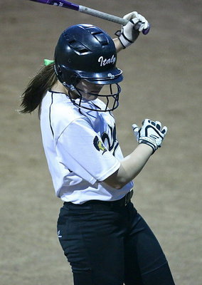 Image: Lillie Perry(9) takes a practice swing before stepping into the batter’s box against Frost.