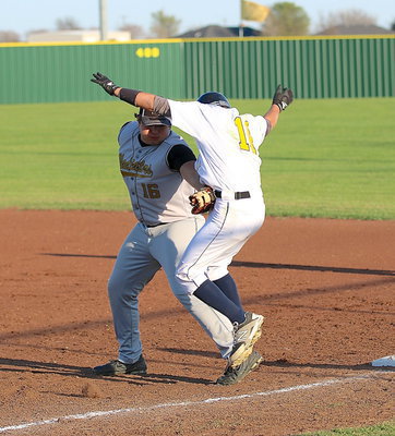 Image: Kevin Roldan(16) makes the tag after being pulled away from the first-base bag.