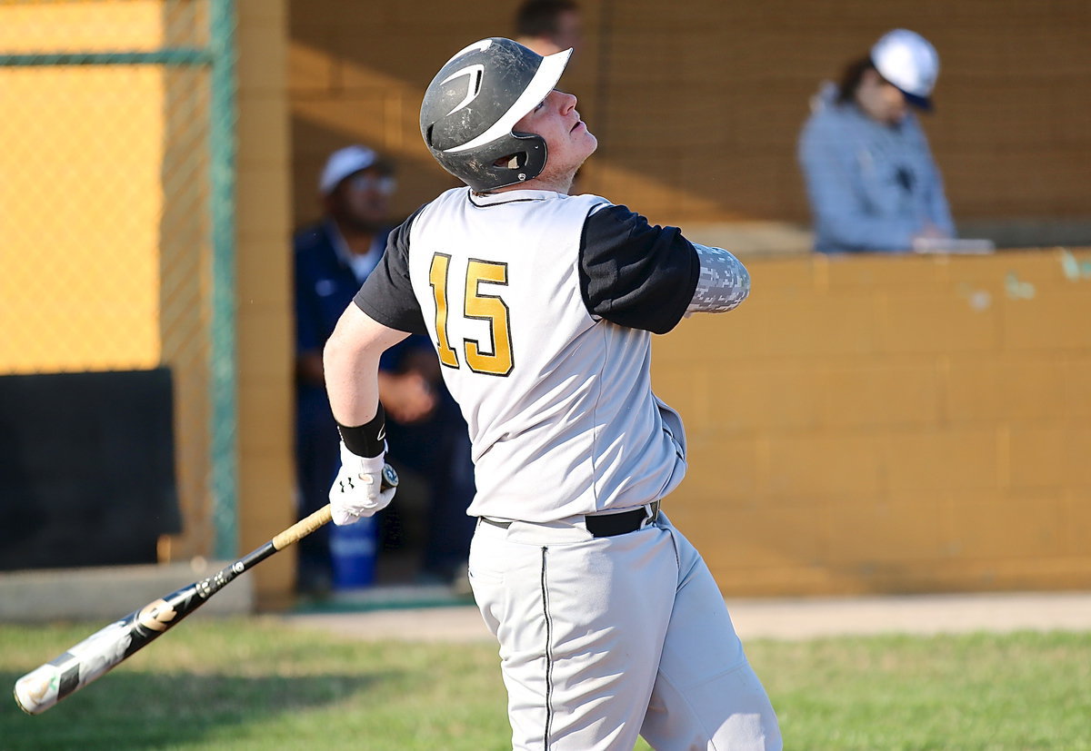 Image: Tyler Vencill(15) gets one to drop down in the outfield for a base hit.