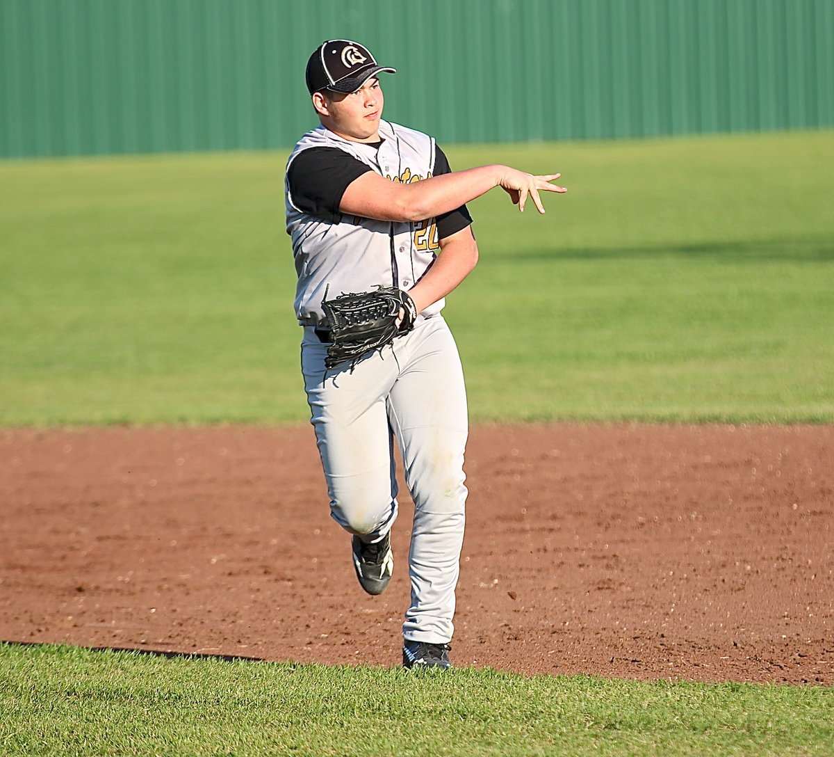 Image: Second-baseman Zain Byers(20) charges a grounder and then throws on the run to teammate Kevin Roldan for an out at first-base.