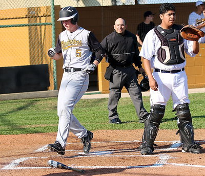 Image: Cody Boyd(5) steps on home plate for the fourth time against the Eagles.
