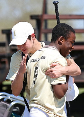 Image: Kyle Tindol hugs teammate Kendrick Norwood after their win on IYAA Opening Day 2014.