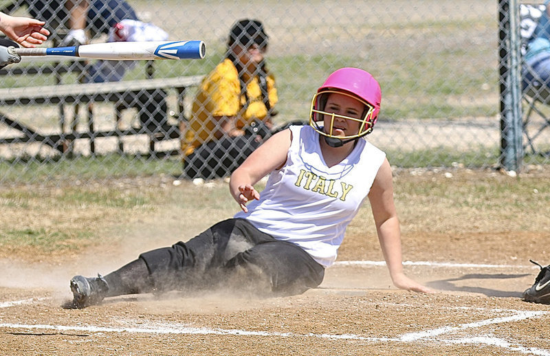Image: Jill Varner gets down and dirty as she slides across home plate for an Italy run.