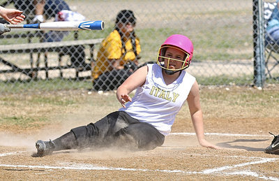 Image: Jill Varner gets down and dirty as she slides across home plate for an Italy run.