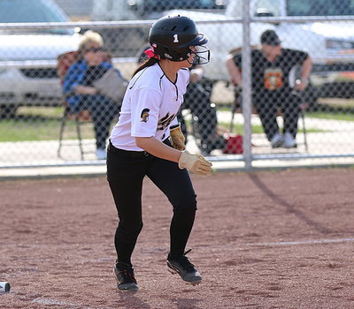 Image: Hurrying to first-base is Bailey Eubank after she slap hits the ball into play.