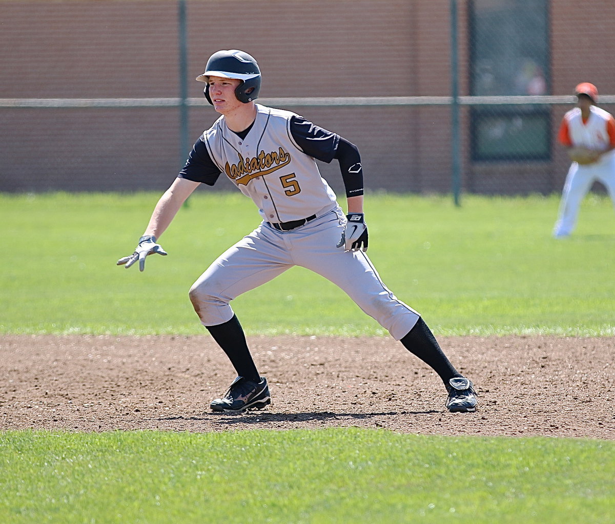 Image: Junior Gladiator Cody Boyd(5) leans toward third-base.