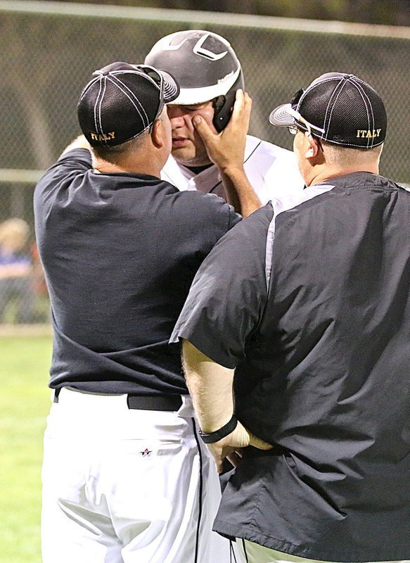 Image: Kevin Roldan(16) is checked out by coaches Jackie Cate and Brandon Ganske after taking a pitch to the face.