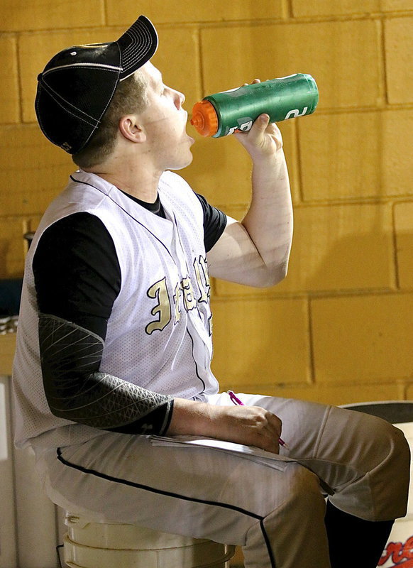 Image: John Escamilla(7) stays hydrated with the game growing in intensity with each passing inning.