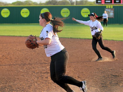 Image: Paige Westbrook(10) fields a grounder hit to first-base, tags the bag for the out and then rushes across the infield to hold an Itasca runner at third. Notice second-baseman Bailey Eubank(1) directing the action.