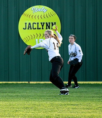 Image: Kelsey Nelson(14) tracks down a ball in center field with Tara Wallis(5) backing her up from right.
