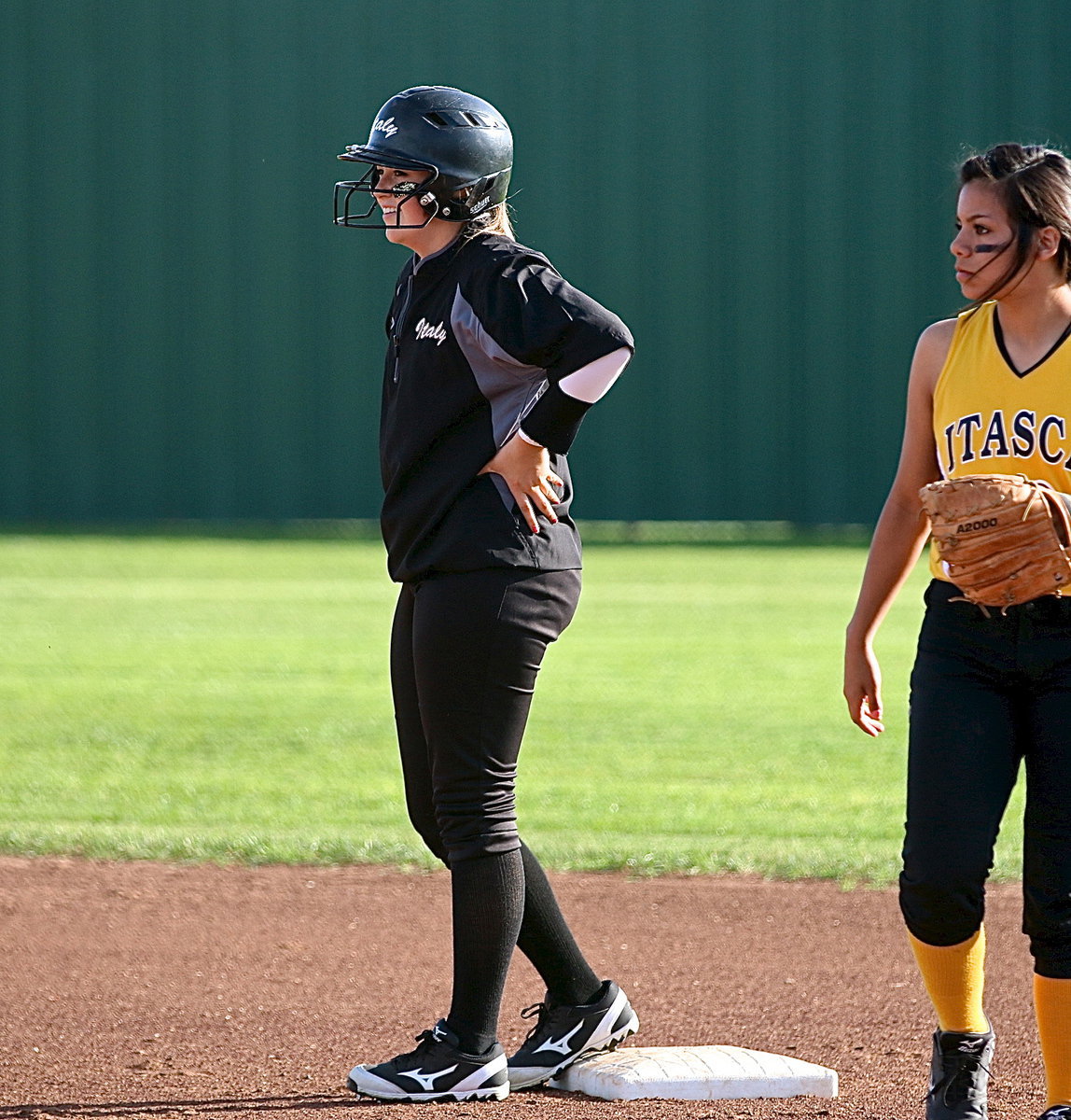 Image: Kelsey Nelson(14) is all smiles after turning on a pitch for a double hit to left field, sending a message to Itasca.