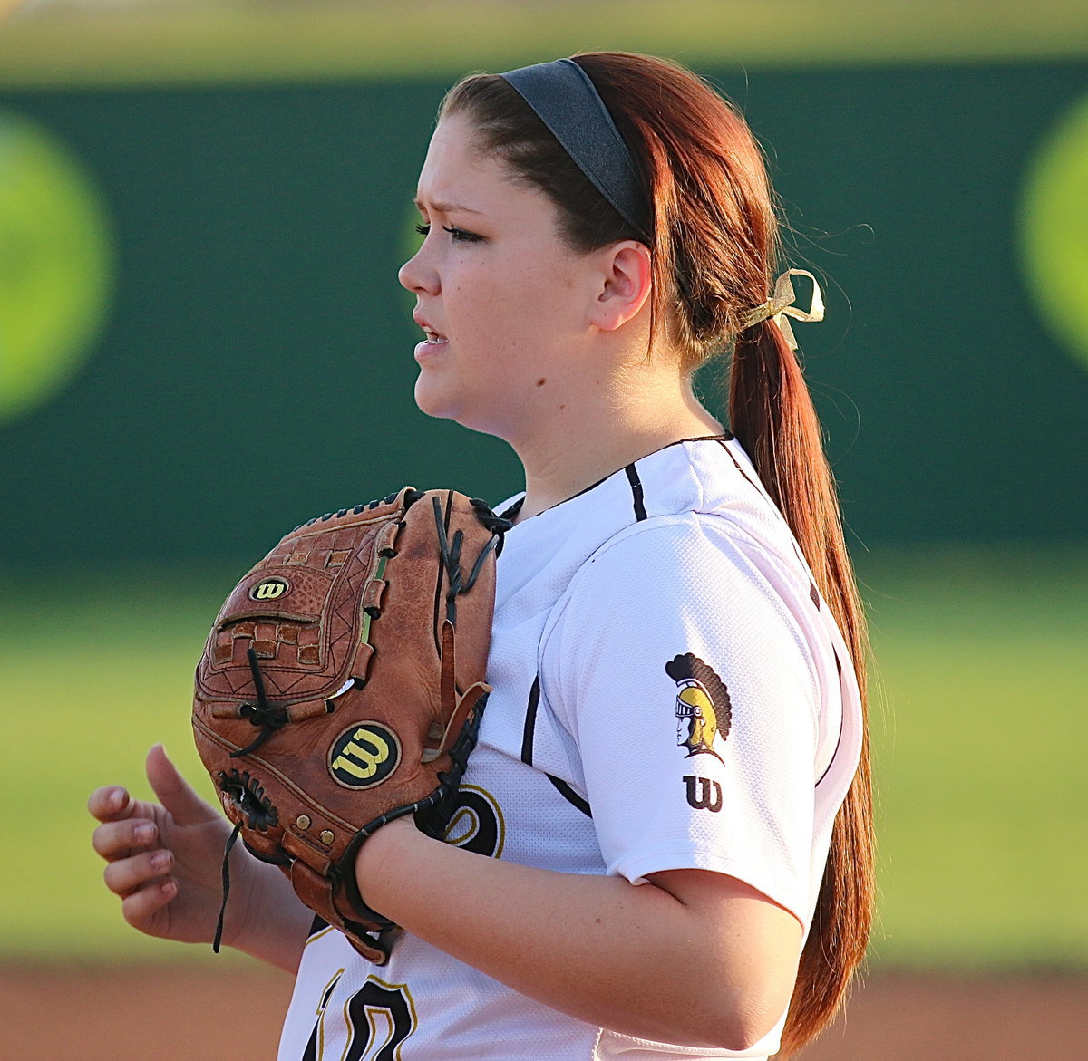 Image: Senior leader Paige Westbrook(10) encourages her teammates while covering first-base.