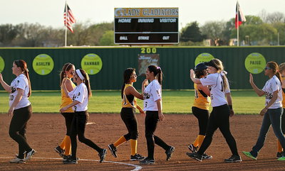 Image: Paige Westbrook, Cassidy Childers, Ashlyn Jacinto, Jaclynn Lewis and April Lusk display sportsmanship after the game.