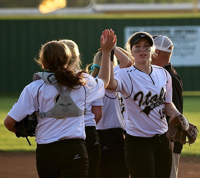 Image: Pitcher Jaclynn Lewis(15) lets her catcher, Lillie Perry(9), know her hard work was appreciated.