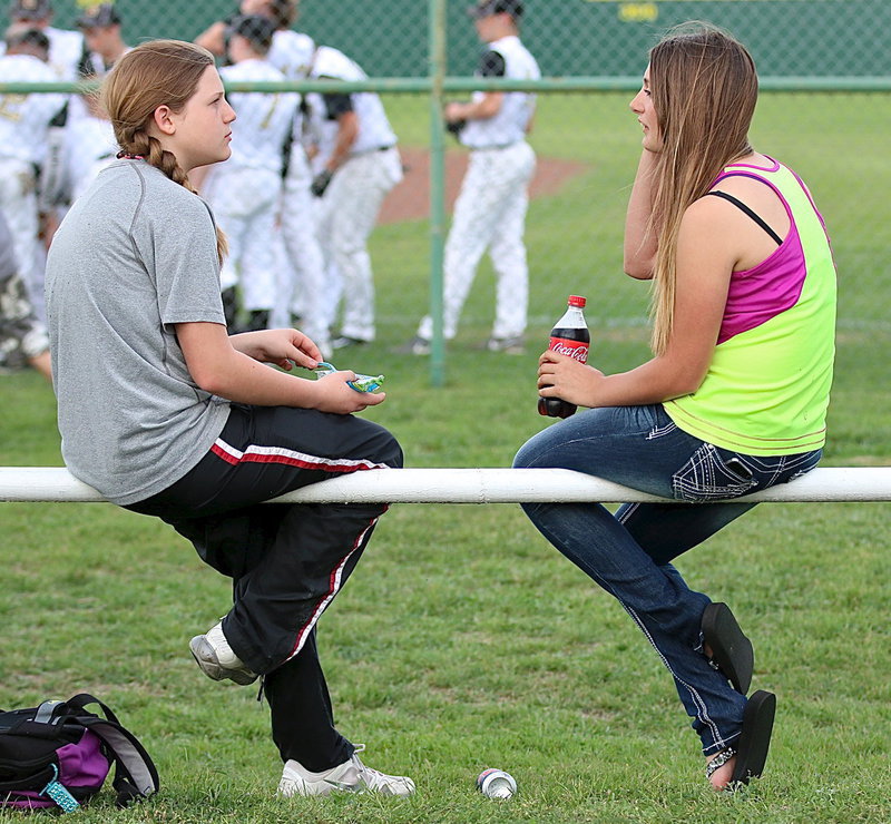 Image: Tatum Adams and Cassidy Gage visit before the start of the game between Italy and Itasca.