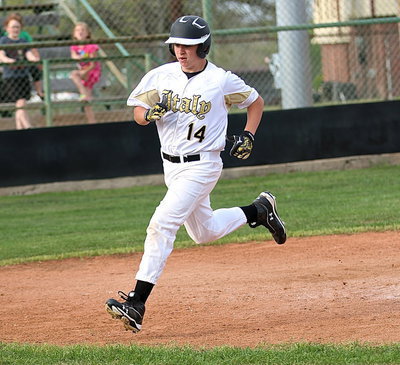 Image: Austin Crawford(14) scores from third to pull Italy’s JV Gladiators within 1 run of Milford, 6-5.