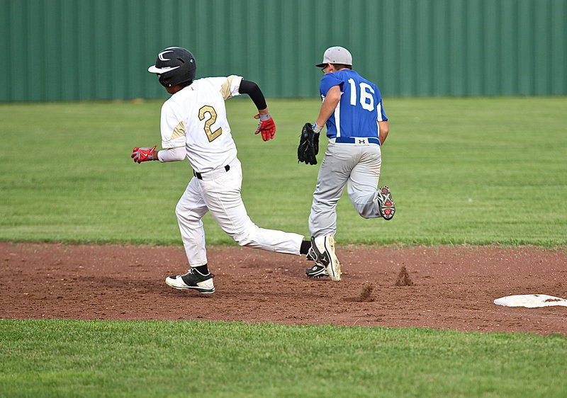 Image: A hit by Hunter Ballard allows teammate Jorge Galvan(2) to reach third all the way from first-base.