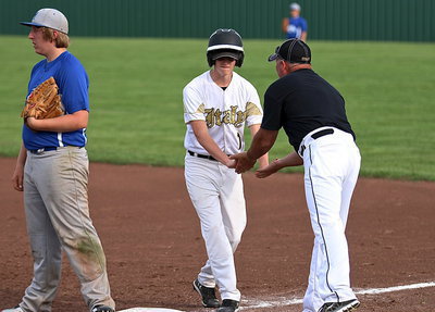 Image: Hunter Ballard(1) is pumped after his single puts a runner in scoring position as first-base coach Jackie Cate slaps hands with Ballard in excitement.