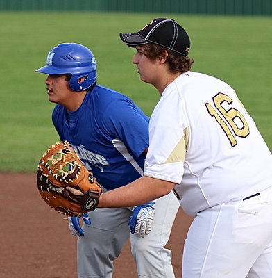 Image: Italy first-baseman Sam Corley(16) tries to keep Milford’s go ahead runner close to the bag.